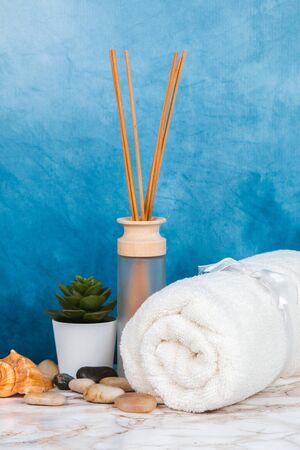 Spa objects and elements on a marble table and blue backgroundの写真素材