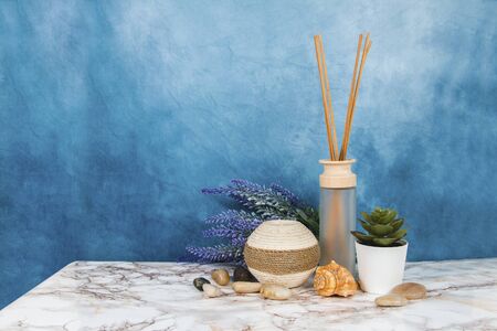 Spa objects and elements on a marble table and blue backgroundの写真素材