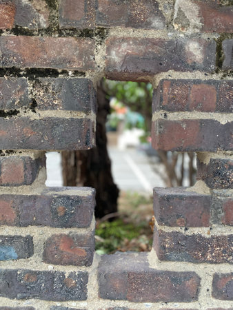 Old brick wall with hole in the middle. Shallow depth of fieldの写真素材