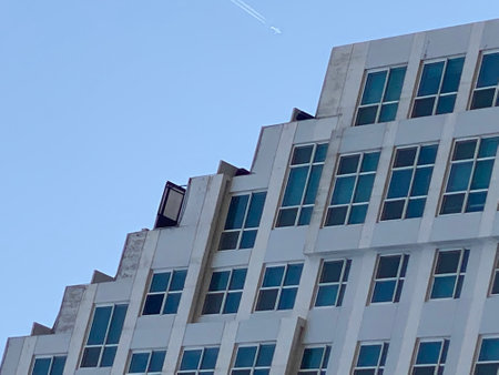 Modern office building on a background of blue sky. Architectural details.