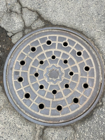 Manhole cover on the street, closeup of photo with selective focus