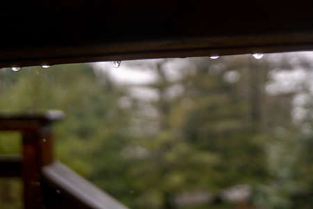 Rain drops on the roof of the house. Rainy weather.