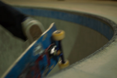Motion blur of a skateboarder riding a skateboard in a skate park