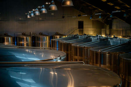 Modern brewery interior. Metal tanks for beer fermentation in a brewery.