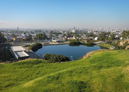 A view of a lake and a city seen from the top of a hill.のeditorial素材