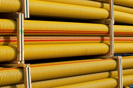 Neatly stacked pipes at a construction site の写真素材