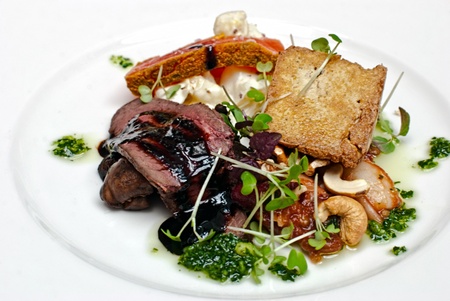 A dish of meat shot in a restaurant の写真素材