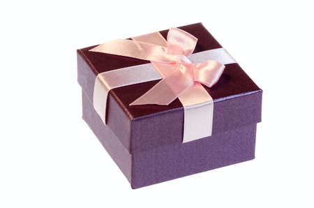 Gift box with a pink ribbon bow isolated on white background の写真素材
