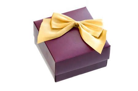 Gift box with a gold ribbon bow isolated on white background の写真素材