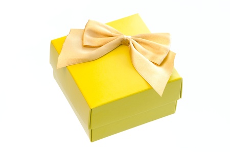 Gift box with a gold ribbon bow isolated on white background の写真素材