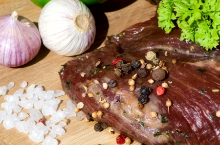 meat with fresh vegetables on wooden boardの写真素材