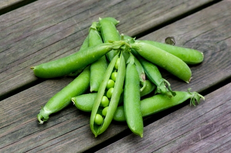 Fresh peas on a background of old boardsの写真素材