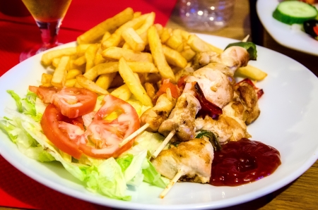 Chicken kebab with potatoes and saladの写真素材
