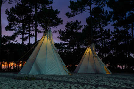 teepees in nature at sunsetの写真素材