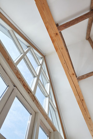 Triangle window going until the frameworks exposed ceiling