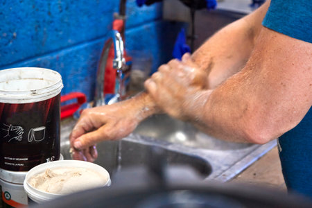 A mechanic washing his hands and arms after work with a very efficient productの写真素材