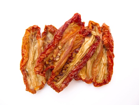 dried natural tomatoes isolated on white backgroundの写真素材