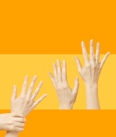 Two pair of female hands reaching out, hands up. Yellow and orange abstract background.  Hands lifted up in the air. Minimal concept.の写真素材