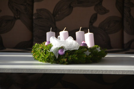 The Christmas wreath with white candles and purple ornamentの写真素材
