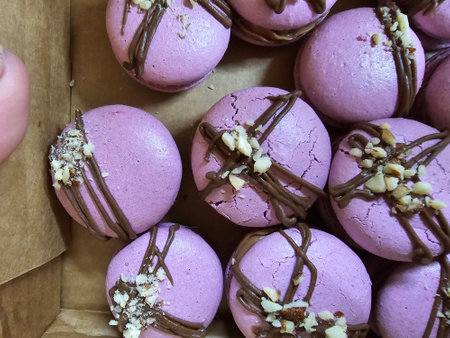 Macaroons with chocolate and nuts on a wooden table. Toned.の写真素材
