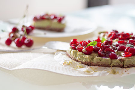 Raw Healthy Paleo Avocado Lemon Cake with Banana and Cherriesの写真素材