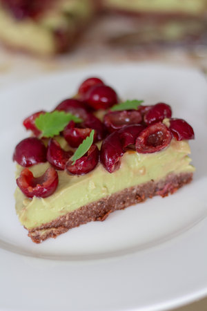Chocolate cake with cherries on a white plate. Selective focus.の写真素材