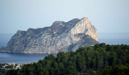 landscape of the rock of ifach, calpe spain. Nightfall shot. Mass of rock, telephoto view. Sea landscapeの写真素材