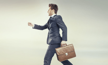 Young businessman running into his big careerの写真素材