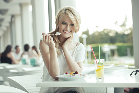 Cute woman enjoying the dessertの写真素材