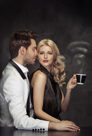 Conceptual portrait of the young attractive couple in the Internet cafeの写真素材