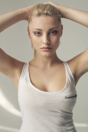 Calm, serious lady making a hairstyleの写真素材