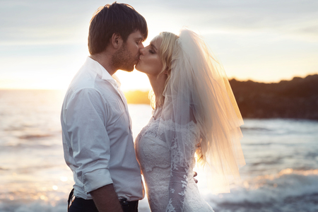 Portrait of a young newlyweds over the sea backgroundの写真素材