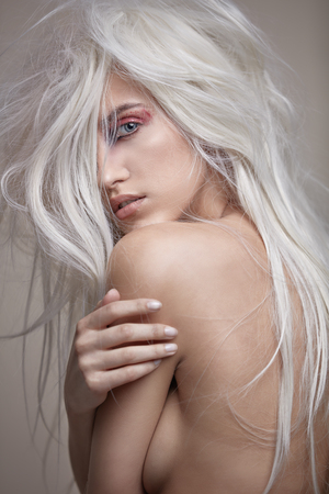 Sensual nude woman with a steely, modern coiffureの写真素材