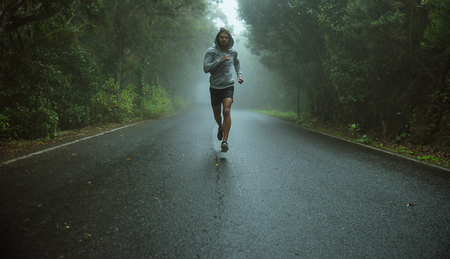 Handsome, young jogger running in the exotic area