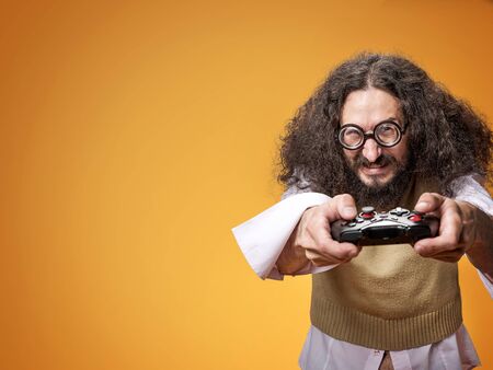 Funny portrait of a slim nerd playing video game