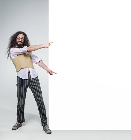 Eccentric guy pointing on the commercial, empty boardの写真素材