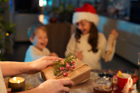 Charming motherpacking christmas presents with childrenの写真素材