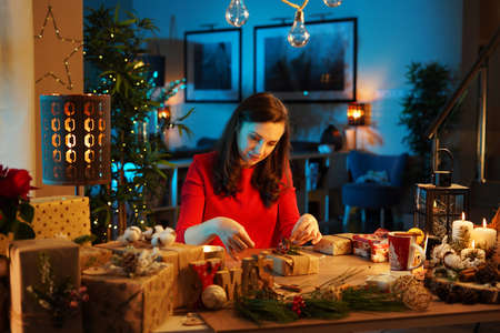 Charming brunette woman drinking an aromatic winter cup of the teaの写真素材