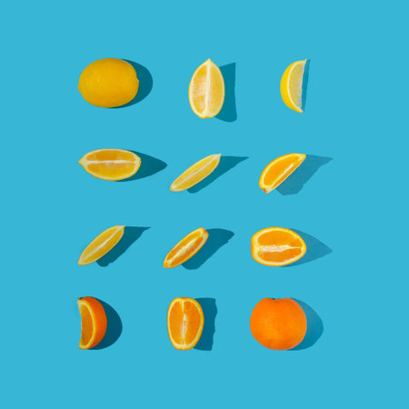 Fresh lemon and orange slices neatly arranged against a pastel light blue background. Minimal flat...