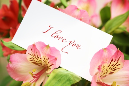 Card in flowers with love wordsの写真素材