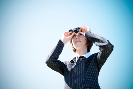 Young caucasian business lady with binocularsの写真素材