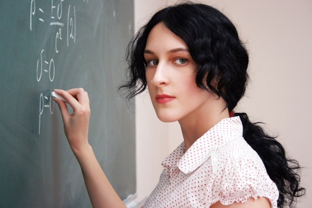 Girl writing formula at the desk