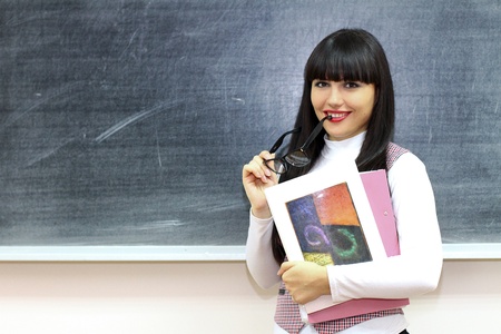 Young caucasian woman near the blackboardの写真素材