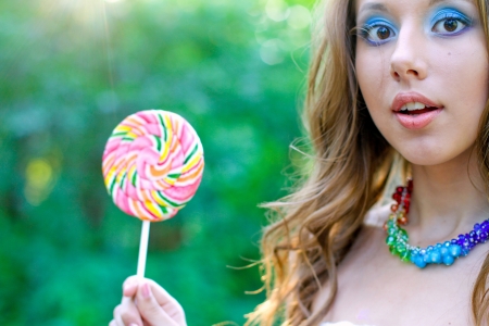 Pretty caucasian woman with bright funny lollipopの写真素材