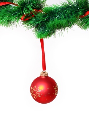 Red ball hanging on green garlandの写真素材