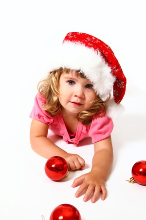 New Year or Christmas sweet baby with Santa Claus hat and red ballsの写真素材