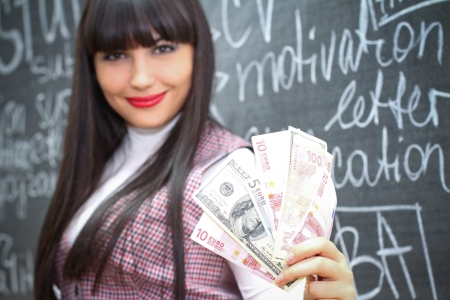 Young caucasian woman near the blackboardの写真素材