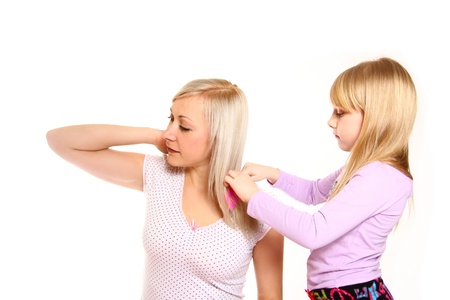 Cute daughter  combing hair  her motherの写真素材