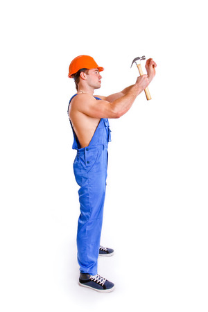 Portrait of sexy mechanic with a hammer isolatedの写真素材