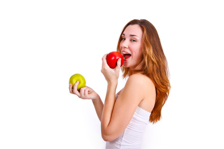 Attractive girl eating apples on  white backgroundの写真素材